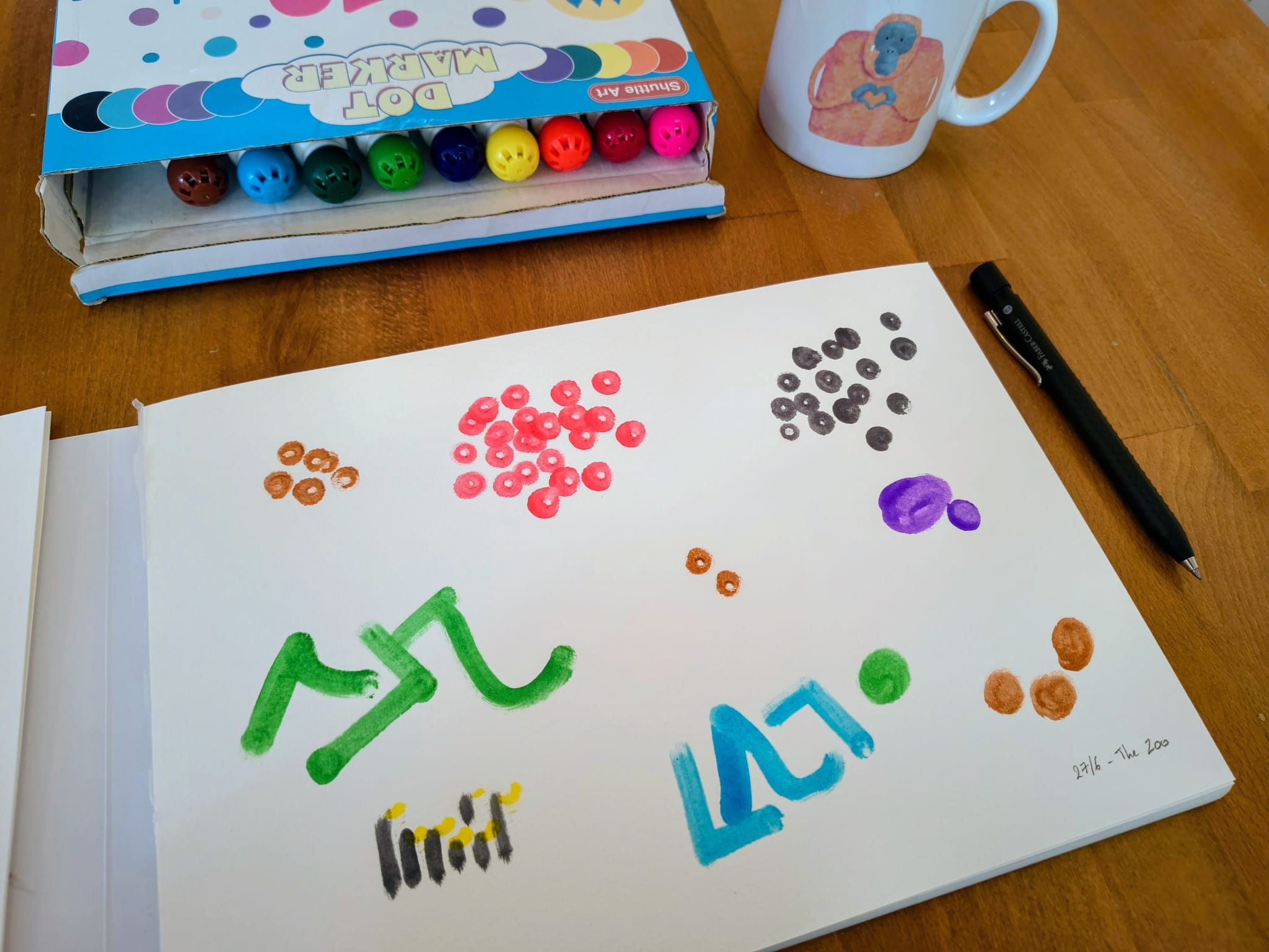 Mark making representation of my trip to the zoo using dot marker pens and paper. Different coloured pens have been used to represent different animals as well as playground equipment.